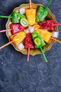 summer dish of ice cream with flavors of kiwi,pomegranate and oranges.Copy space