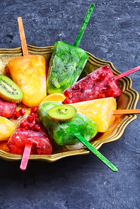 summer dish of ice cream with flavors of kiwi,pomegranate and oranges.View top