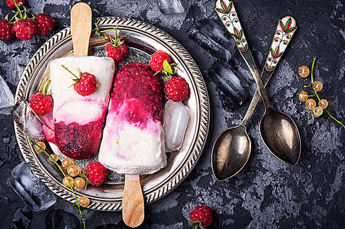 Summer ice cream on a stick with fresh raspberries.Top view, flat lay