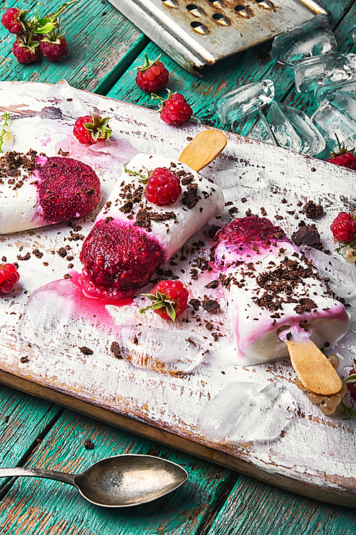 Summer ice cream on a stick with fresh raspberries