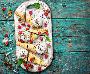 Summer ice cream in a waffle cone dessert with fresh raspberries.Copy space