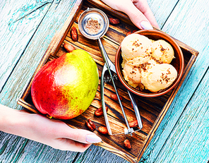 Ice cream, mango fruit and a spoon for ice cream in wooden tray