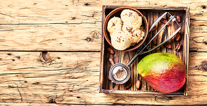 Ice cream, mango fruit and a spoon for ice cream in wooden tray