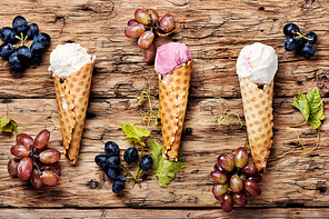 Ice cream sundae, waffle cone.Grape ice cream.Ice cream cones on wooden table