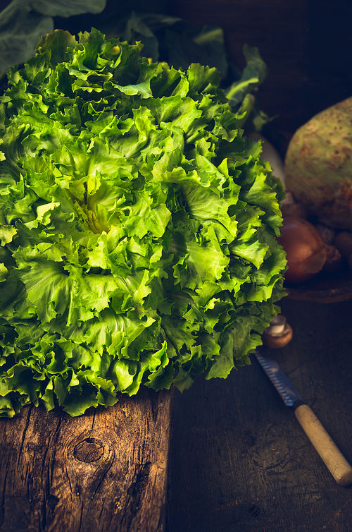 fresh lettuce head on rustic kitchen table over wooden background
