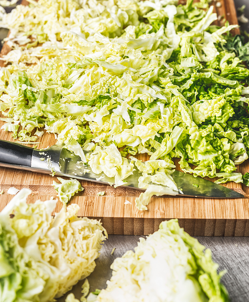 Cut Savoy cabbage with kitchen knife, close up