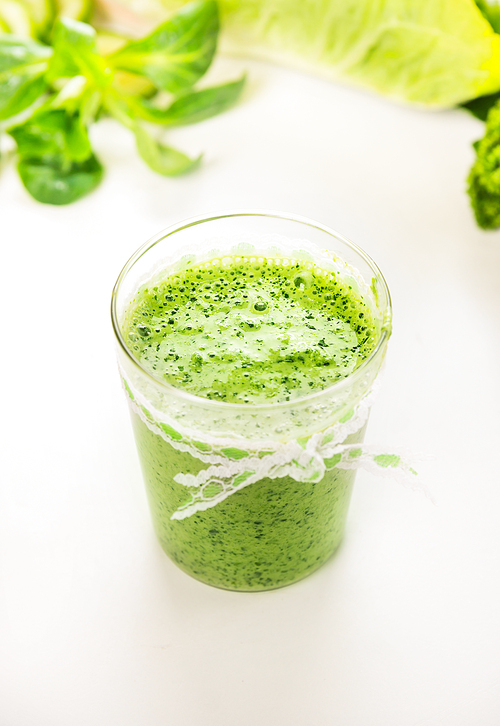Green smoothie in glass, close up