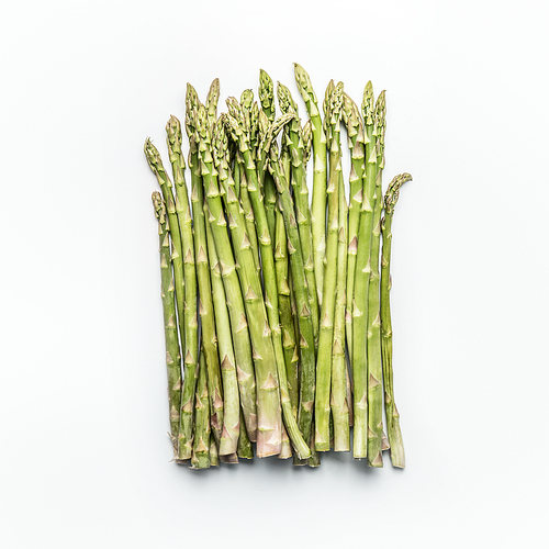 Green asparagus bunch on white background, top view, flat lay. Healthy  seasonal food