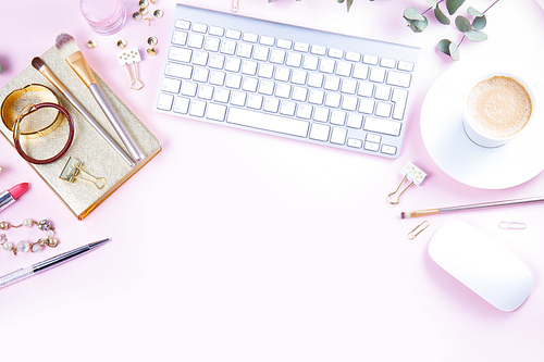 Flat lay home office workspace - white modern keyboard with female accessories and coffee, copy space on pink background