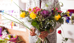 Florist making fashion bouquet of colorfull flowers