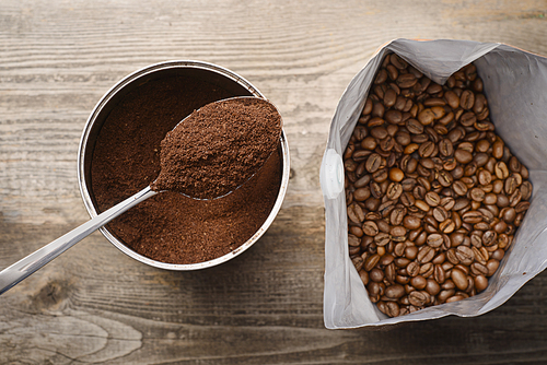 coffee beans and ground coffee on wooden background