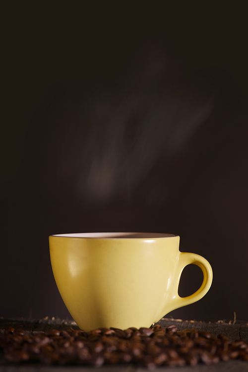 yellow Cup with coffee on a dark background