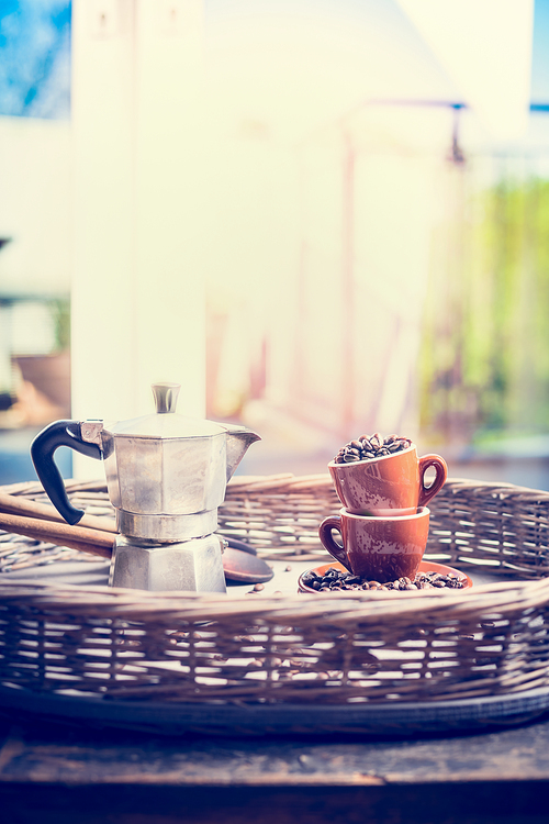 Morning home scene with espresso set , coffee cups, beans and coffee pot over window background