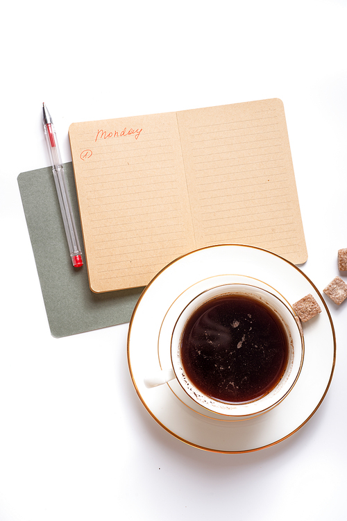cup of coffee with diary  around white background. life style flat lay