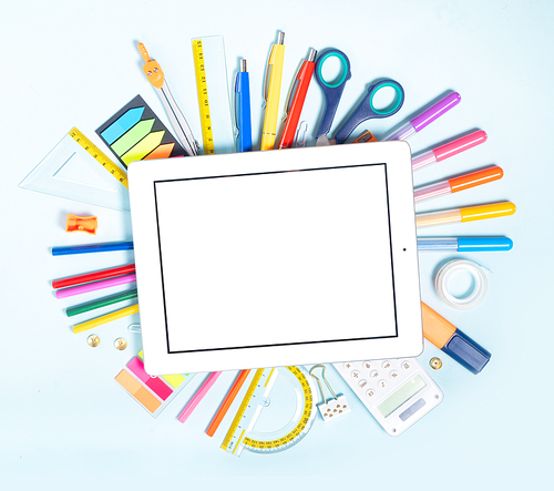 Back to school concept with school supplies on blue background, copy space on ruled paper