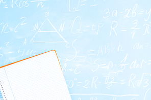 Back to school minimal flat lay styled scene on blue background with math formulas