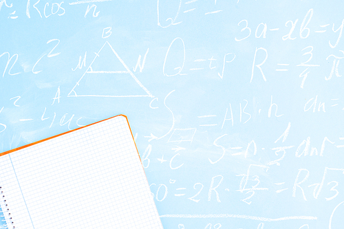 Back to school minimal flat lay styled scene on blue background with math formulas