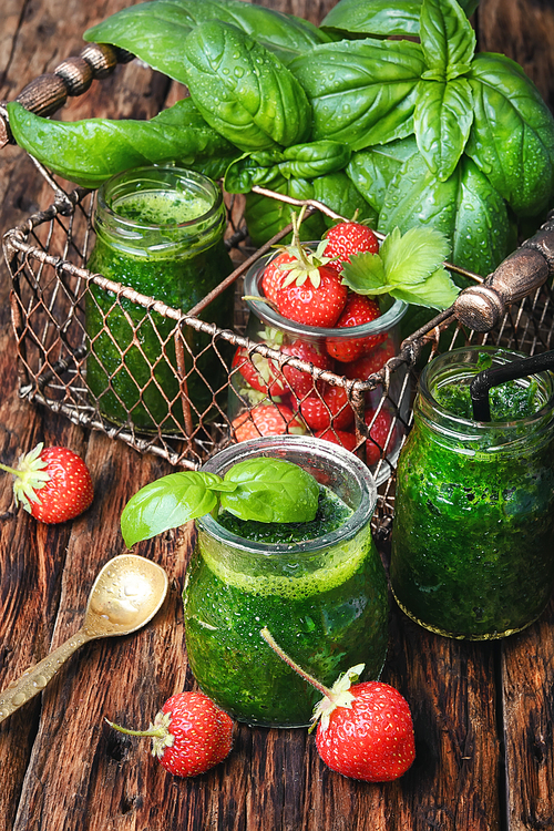 Freshly blended green basil smoothie in glass jar