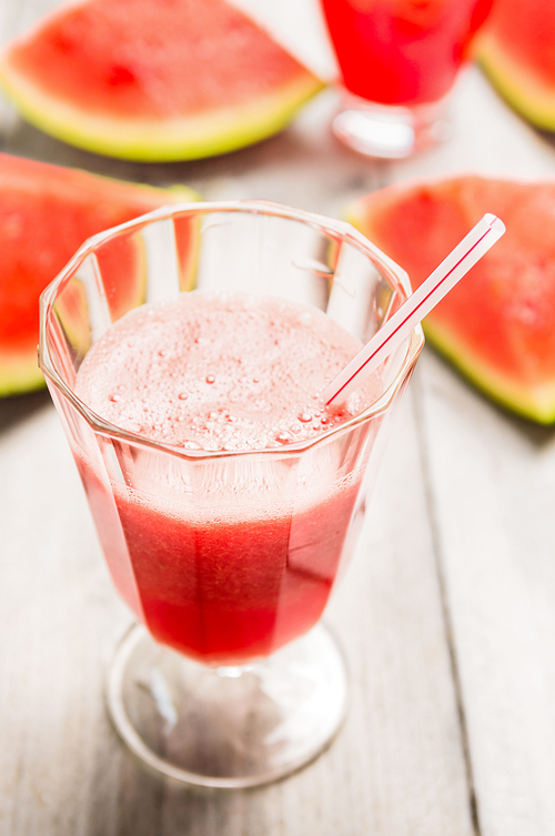 Glass of watermelon smoothie with drink straw, close up
