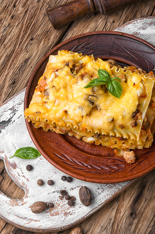 Traditional italian lasagna on wooden rustic background