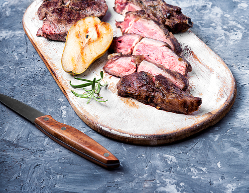 Grilled steak sliced on a cutting board