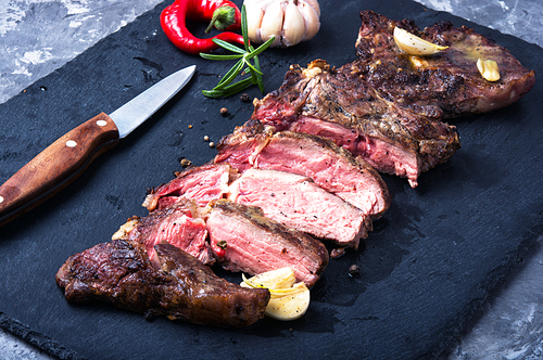 Grilled beef steak sliced on cutting board