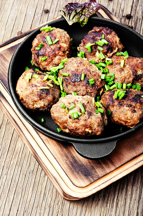 Roasted beef meatballs in cast-iron skillet.Delicious cutlet