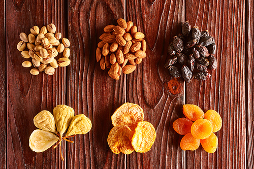 Dried fruits and nuts on vintage rustic wooden background