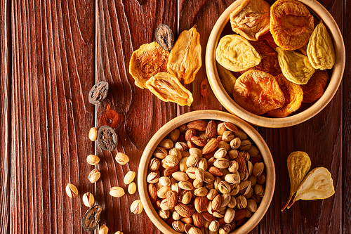 Dried fruits and nuts on vintage rustic wooden background