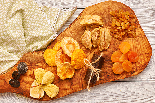 Dried fruits on vintage rustic wooden background