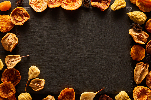 Dried fruits on slate plate background