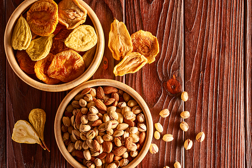 Dried fruits and nuts on vintage rustic wooden background