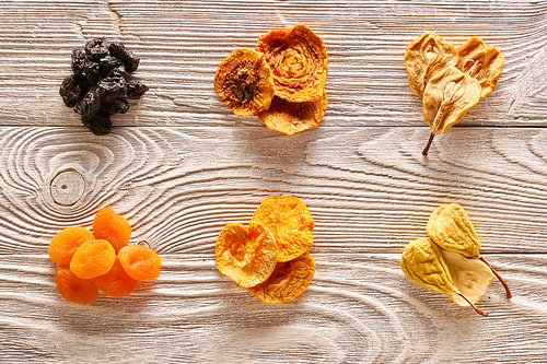 Dried fruits on vintage rustic wooden background