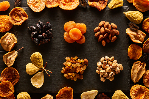 Dried fruits and nuts on slate plate background