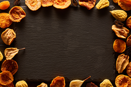 Dried fruits on slate plate background