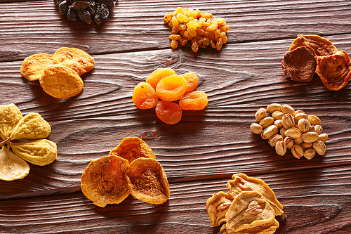 Dried fruits and nuts on vintage rustic wooden background