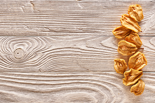 Dried fruits on vintage rustic wooden background