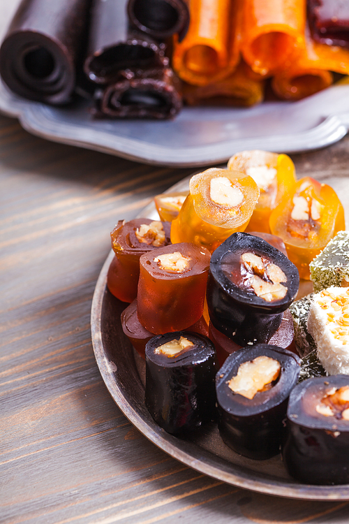 Various types of dry fruit leather with nuts close up