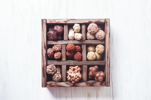 Assorted Chocolate candies in wooden box sells. Luxury handmade sweets