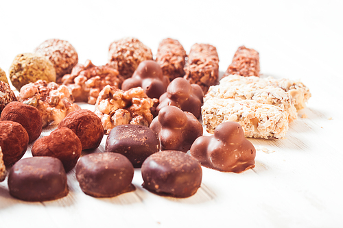 Assorted Chocolate candies on the white table. Luxury handmade sweets