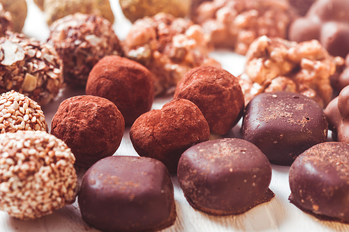 Assorted Chocolate candies on the white table. Luxury handmade sweets