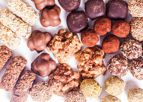 Assorted Chocolate candies on the white table. Luxury handmade sweets