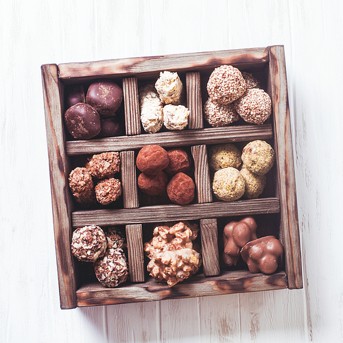 Assorted Chocolate candies in wooden box sells. Luxury handmade sweets