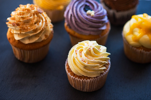Cupcakes desert cream with space for text on a stone background