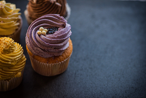 Cupcakes desert cream with space for text on a stone background