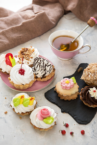 Different cakes composition on concrete background