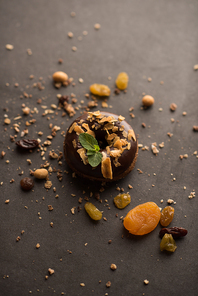 Chocolate Donut with mint leaf on dark stone background