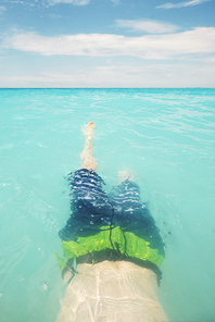 Teen boy swimming in turquoise water in Greece Island