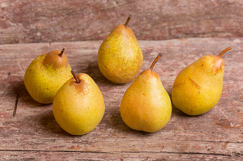 closeup of pears on a old wooden table, studio picture