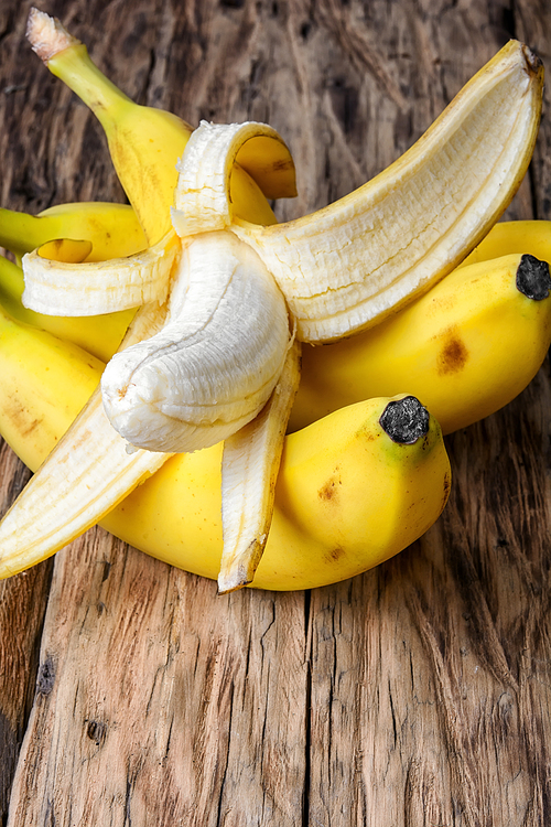 Bunches of ripe bananas on vintage wooden background.Copy space